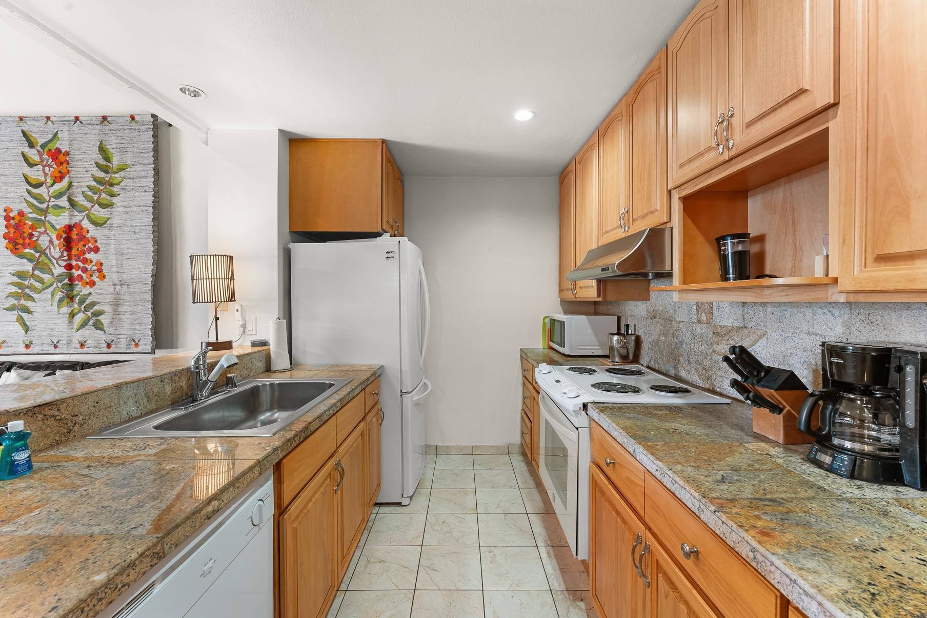 1001 Commonwealth Drive, Unit 101 Kings Beach, CA 96143 - Photo 3 of 28 a kitchen with stainless steel appliances granite countertop a sink stove and refrigerator