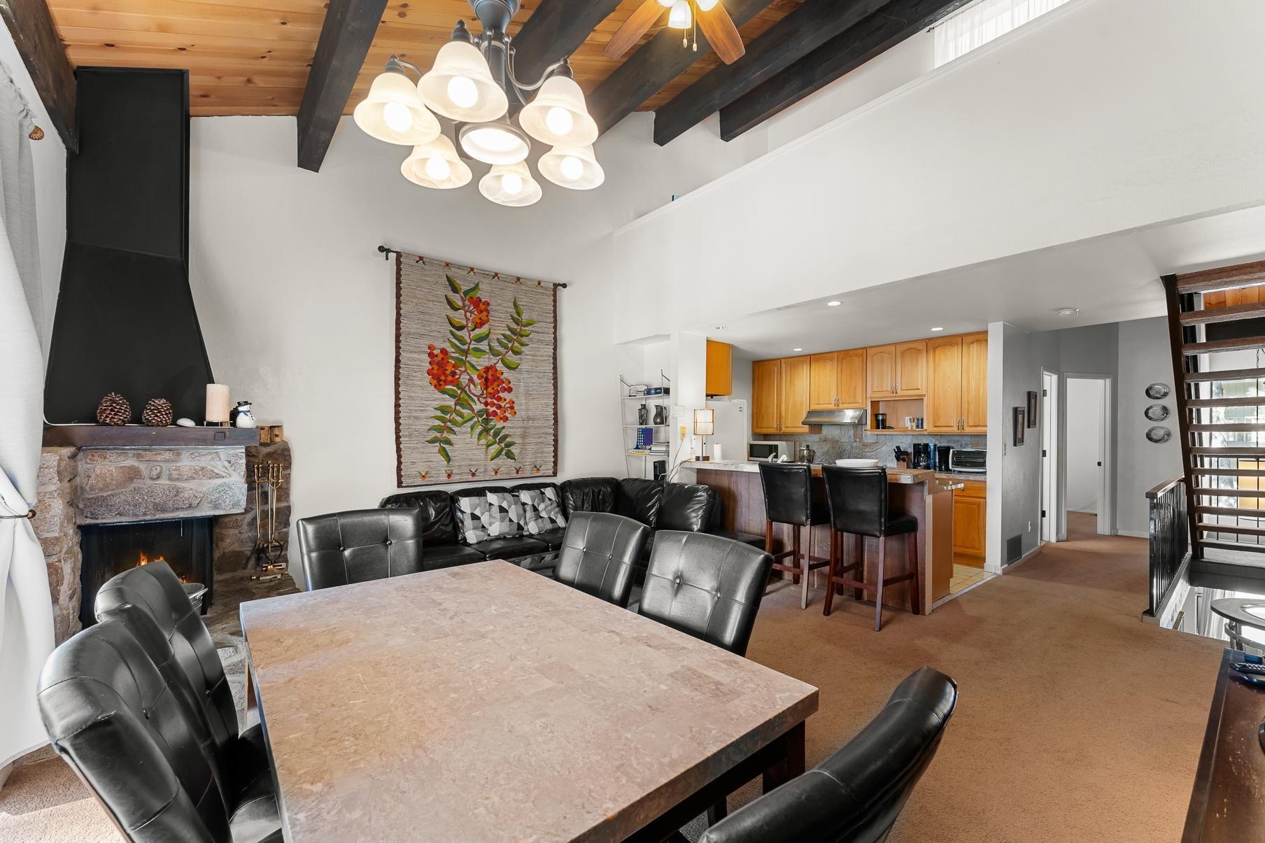 1001 Commonwealth Drive, Unit 101 Kings Beach, CA 96143 - Photo 7 of 28 a view of a dining room with furniture and a fireplace