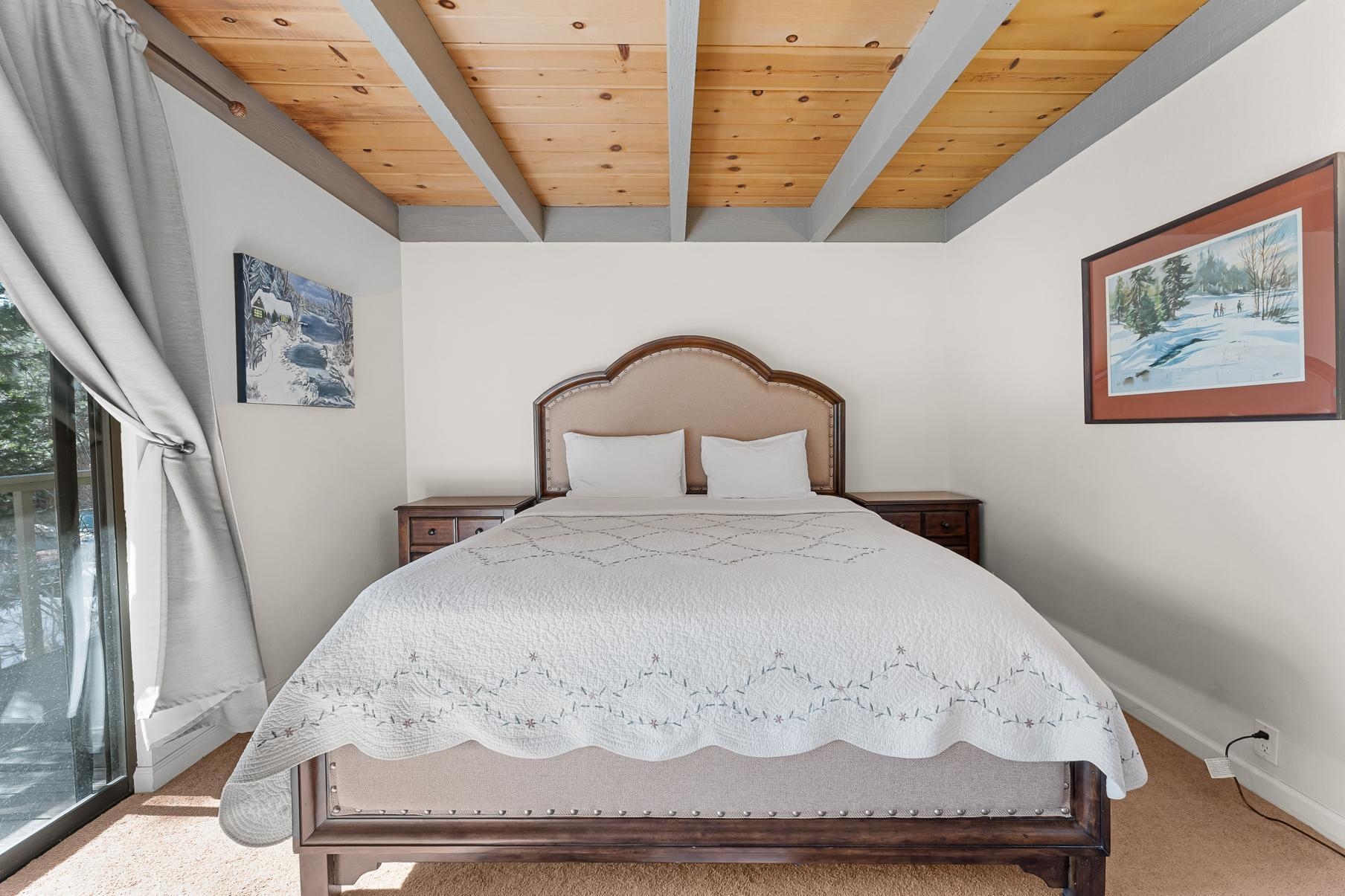 1001 Commonwealth Drive, Unit 101 Kings Beach, CA 96143 - Photo 9 of 28 a bedroom with a bed and a painting on the wall