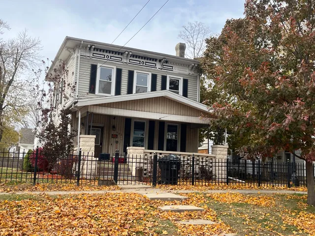 a front view of a house with a iron fence