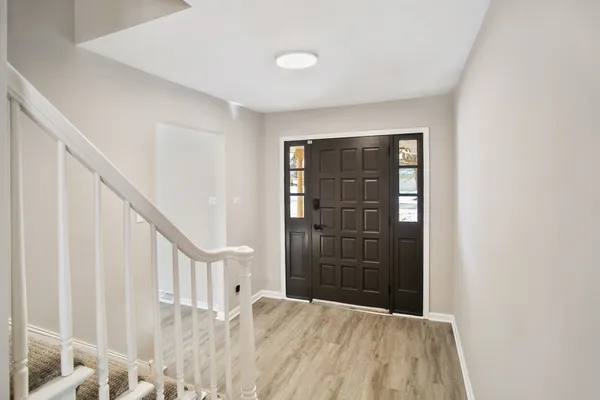 a view of an entryway with wooden floor