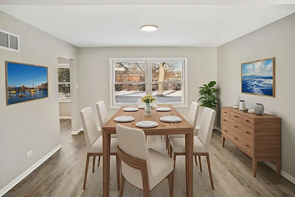 a view of a dining room with furniture window and wooden floor