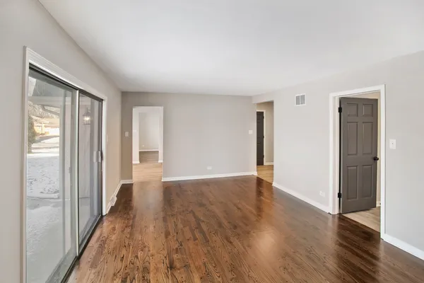 wooden floor in an empty room with a window