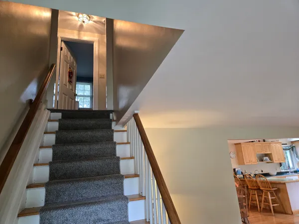 a view of entryway and hall with wooden floor