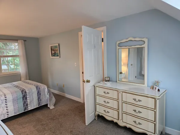 a bedroom with a bed and a dresser