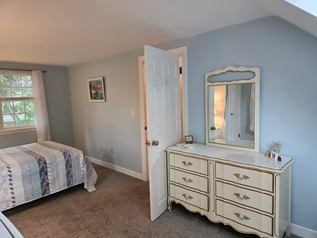 a bedroom with a bed and a dresser