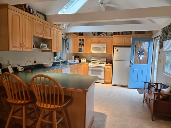 a kitchen with granite countertop lots of appliances and furniture