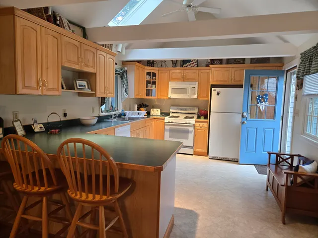 a kitchen with granite countertop lots of appliances and furniture