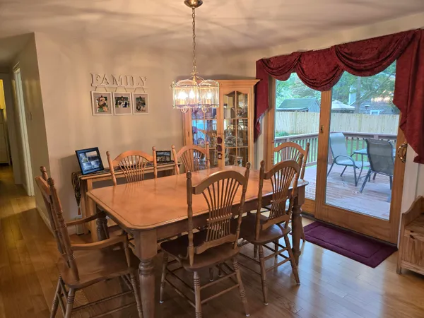 a view of a dining room and hall with furniture