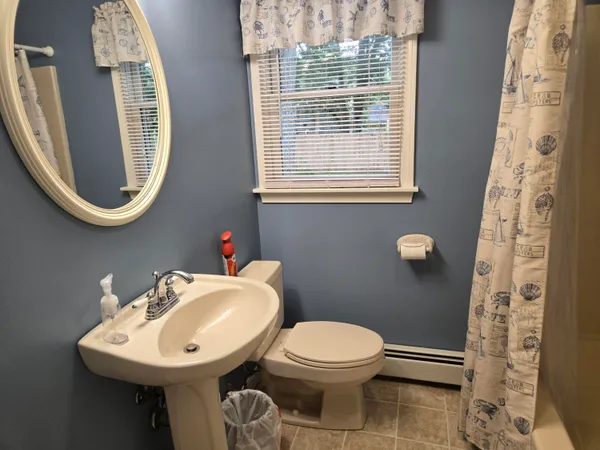 a bathroom with a toilet sink and mirror