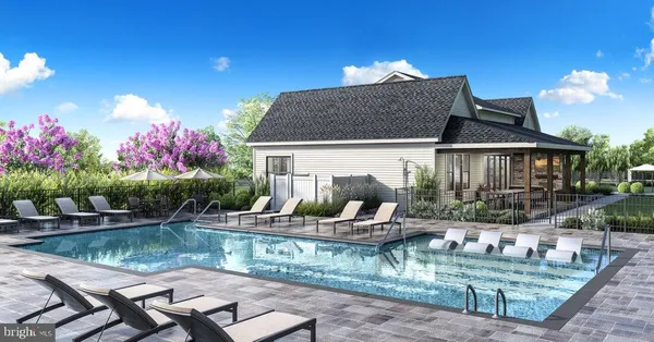 a front view of house with outdoor seating and lake