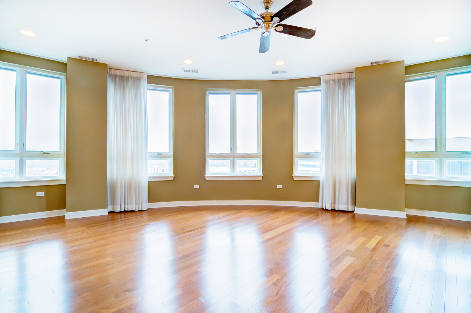 6000 North Cicero Avenue, Unit 511 Chicago, IL 60646 - Photo 2 of 19 a view of an empty room with window and wooden floor