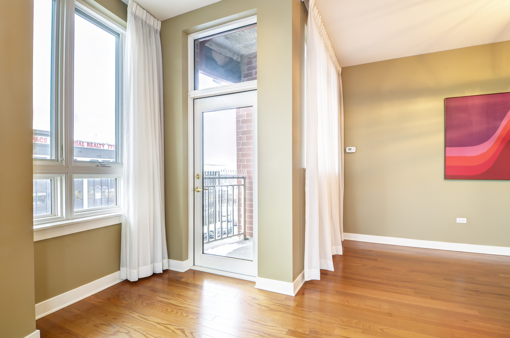 6000 North Cicero Avenue, Unit 511 Chicago, IL 60646 - Photo 3 of 19 a view of an empty room with wooden floor and a window