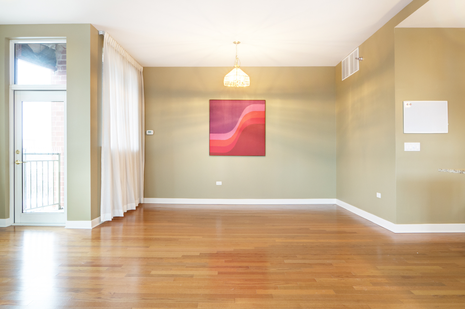 6000 North Cicero Avenue, Unit 511 Chicago, IL 60646 - Photo 4 of 19 a view of an empty room with window and wooden floor