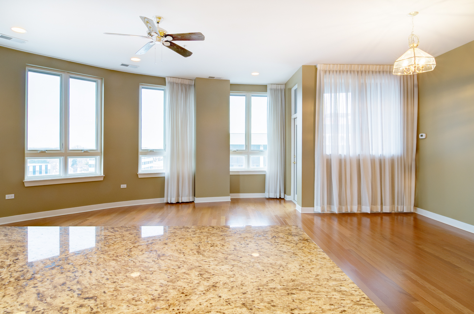 6000 North Cicero Avenue, Unit 511 Chicago, IL 60646 - Photo 5 of 19 a view of an empty room with glass door and wooden floor