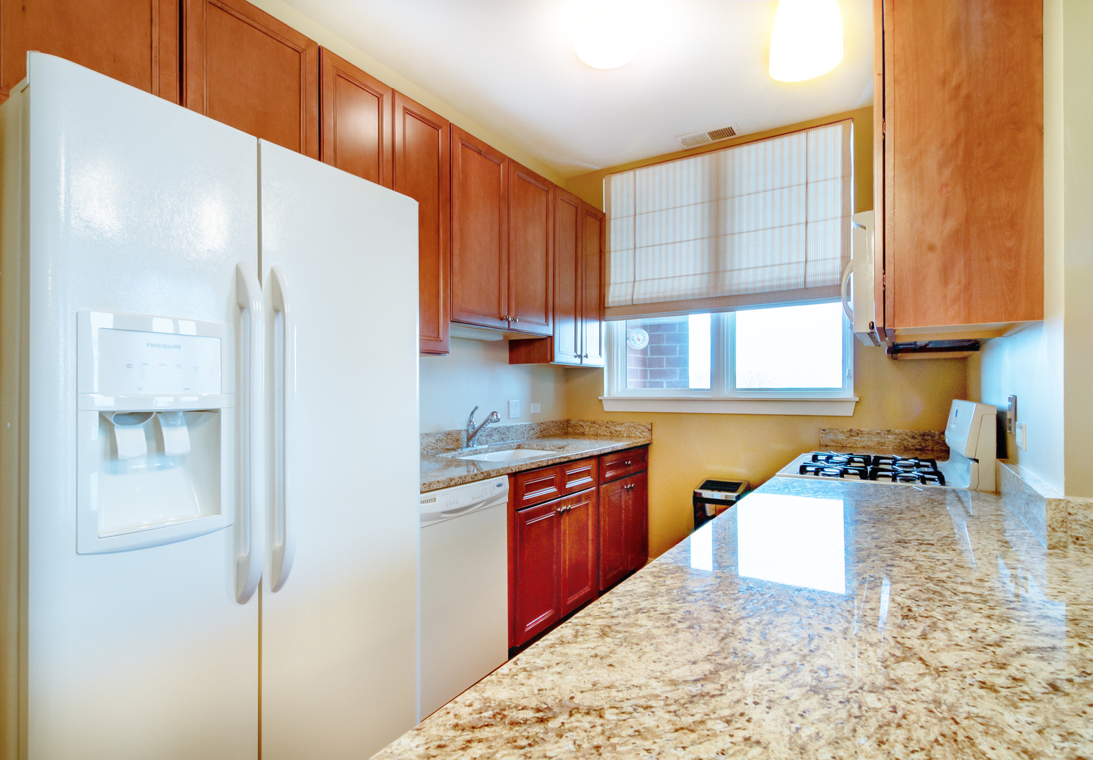6000 North Cicero Avenue, Unit 511 Chicago, IL 60646 - Photo 8 of 19 a kitchen with stainless steel appliances granite countertop a refrigerator sink and wooden cabinets