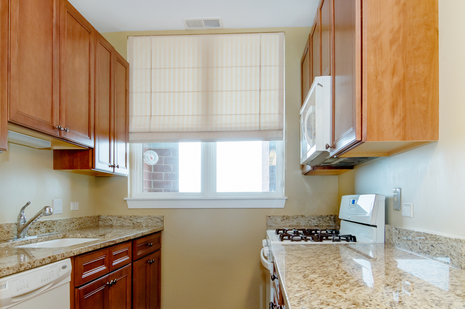 6000 North Cicero Avenue, Unit 511 Chicago, IL 60646 - Photo 9 of 19 a kitchen with stainless steel appliances granite countertop a sink a stove and a microwave