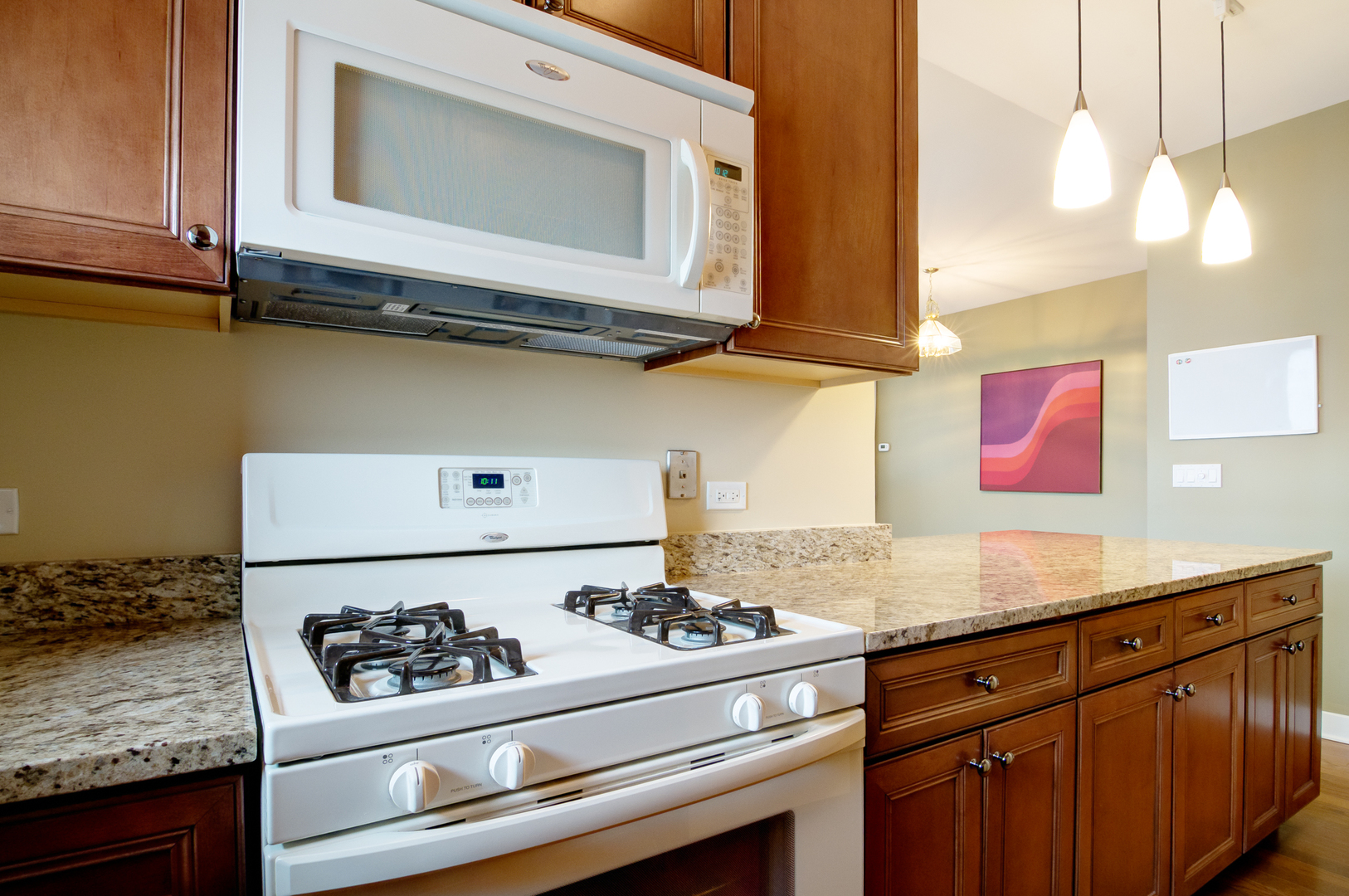 6000 North Cicero Avenue, Unit 511 Chicago, IL 60646 - Photo 10 of 19 a kitchen with stainless steel appliances granite countertop a stove a sink and a microwave
