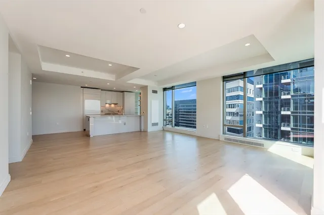 a kitchen with kitchen island a sink a stove a refrigerator and a cabinets