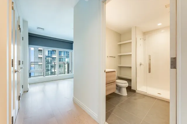 a large bedroom with a large bed and a flat screen tv