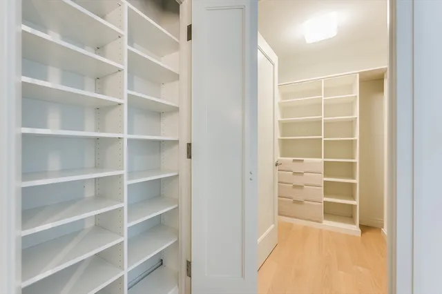 a spacious bathroom with a double vanity sink mirror and bathtub