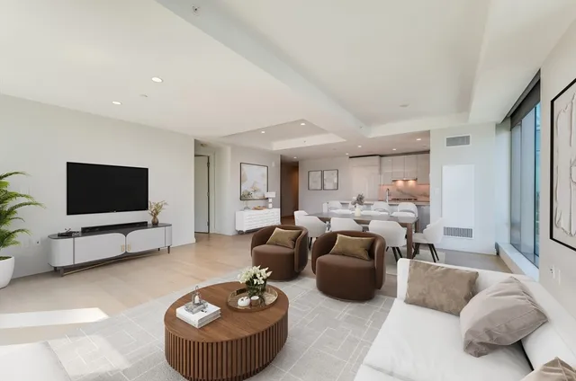 a large white room with large windows and wooden floor