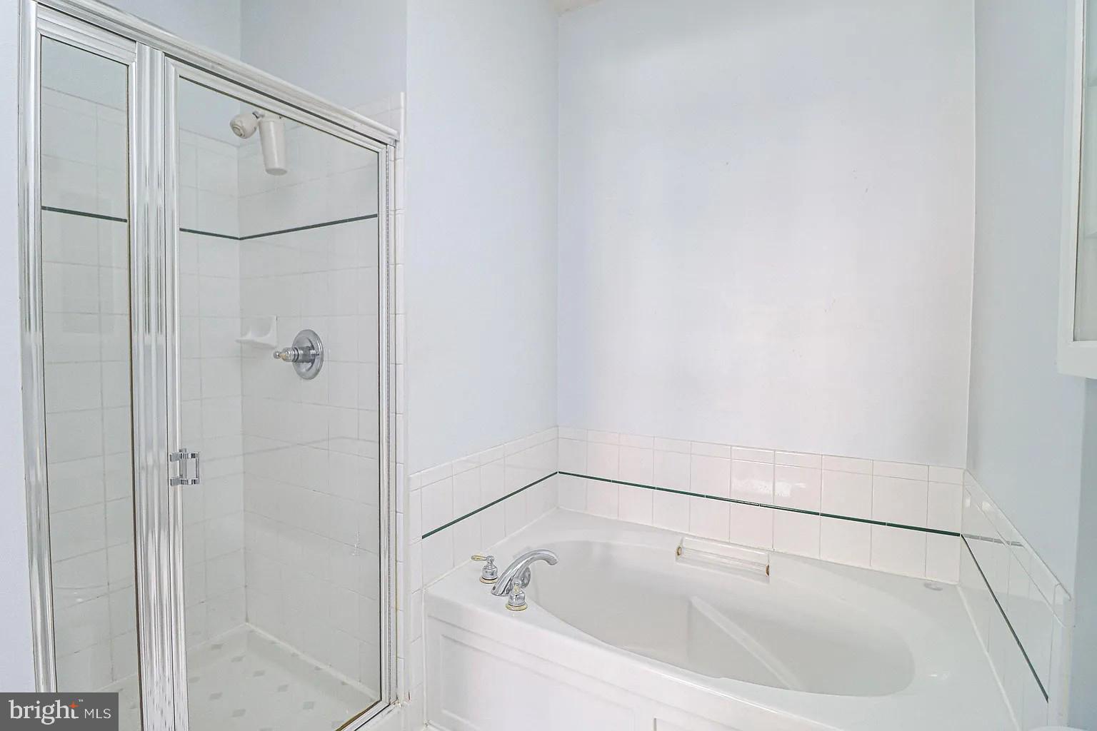 12185 Abington Hall Place, Unit 201 Reston, VA 20190 - Photo 12 of 32 a bathroom with a white bath tub and shower
