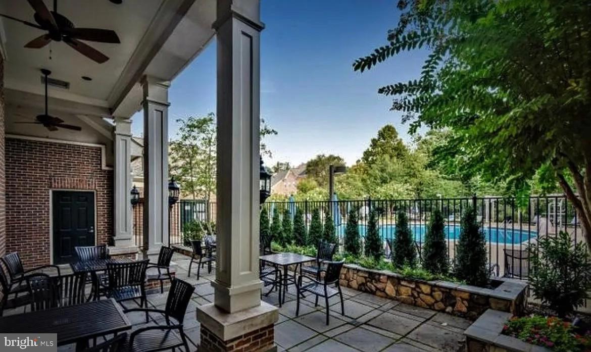 12185 Abington Hall Place, Unit 201 Reston, VA 20190 - Photo 23 of 32 a view of a chairs and table in patio with wooden fence