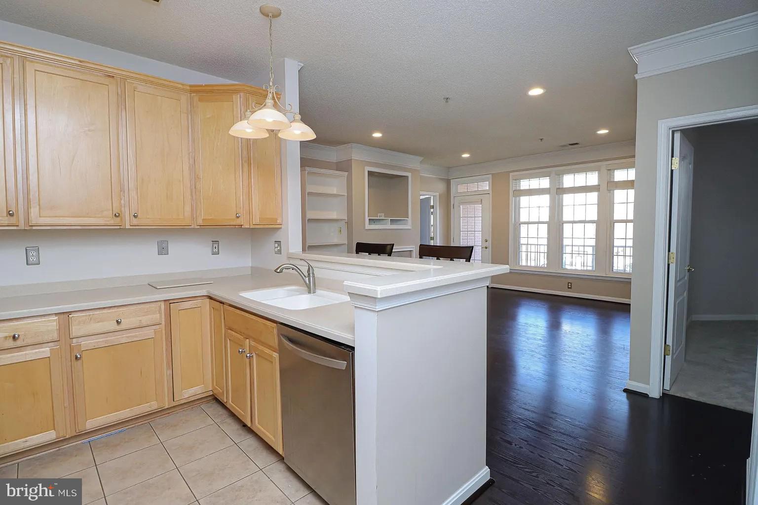 12185 Abington Hall Place, Unit 201 Reston, VA 20190 - Photo 3 of 32 a kitchen with granite countertop white cabinets and white appliances