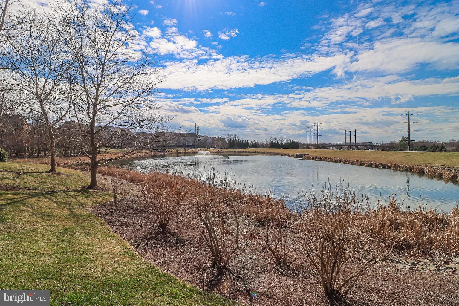 12185 Abington Hall Place, Unit 201 Reston, VA 20190 - Photo 32 of 32 a view of a lake with houses in the back