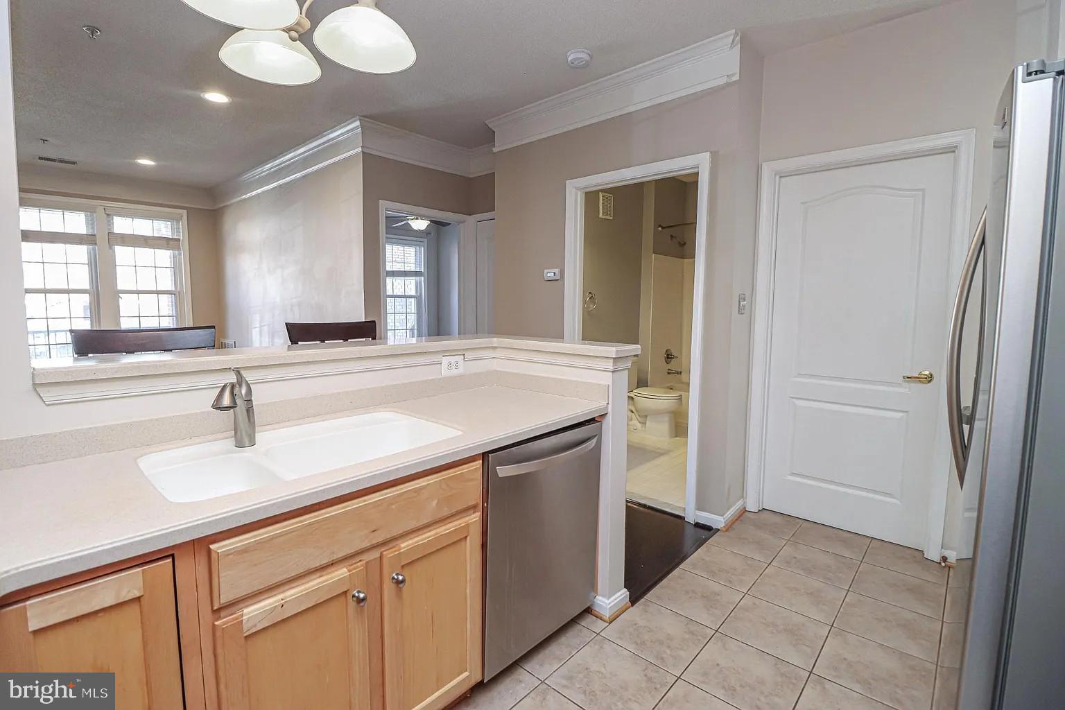 12185 Abington Hall Place, Unit 201 Reston, VA 20190 - Photo 4 of 32 a bathroom with a sink and a mirror
