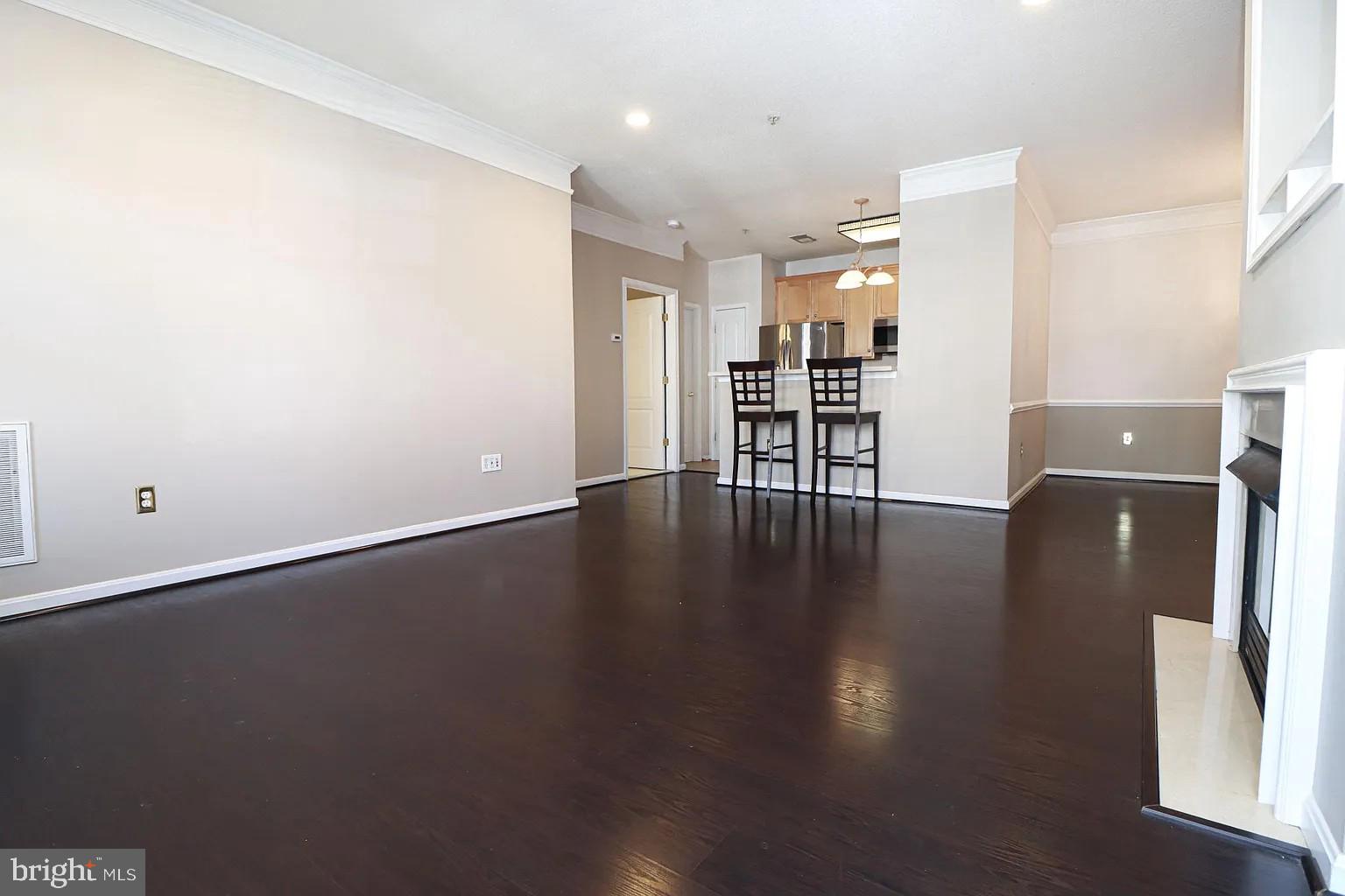 12185 Abington Hall Place, Unit 201 Reston, VA 20190 - Photo 7 of 32 an empty room with wooden floor and a window