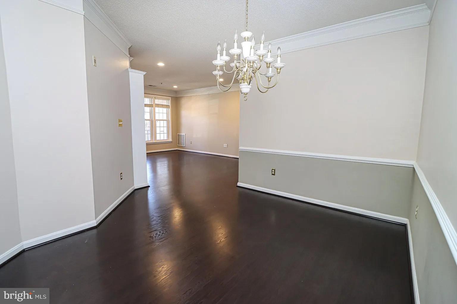 12185 Abington Hall Place, Unit 201 Reston, VA 20190 - Photo 8 of 32 a view of an empty room with wooden floor