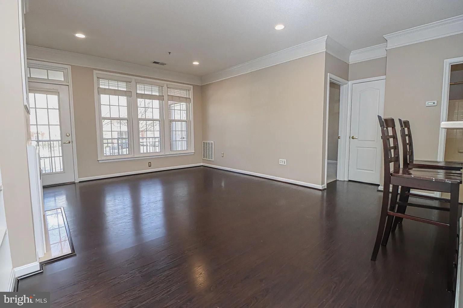 12185 Abington Hall Place, Unit 201 Reston, VA 20190 - Photo 9 of 32 a view of empty room with wooden floor and fan