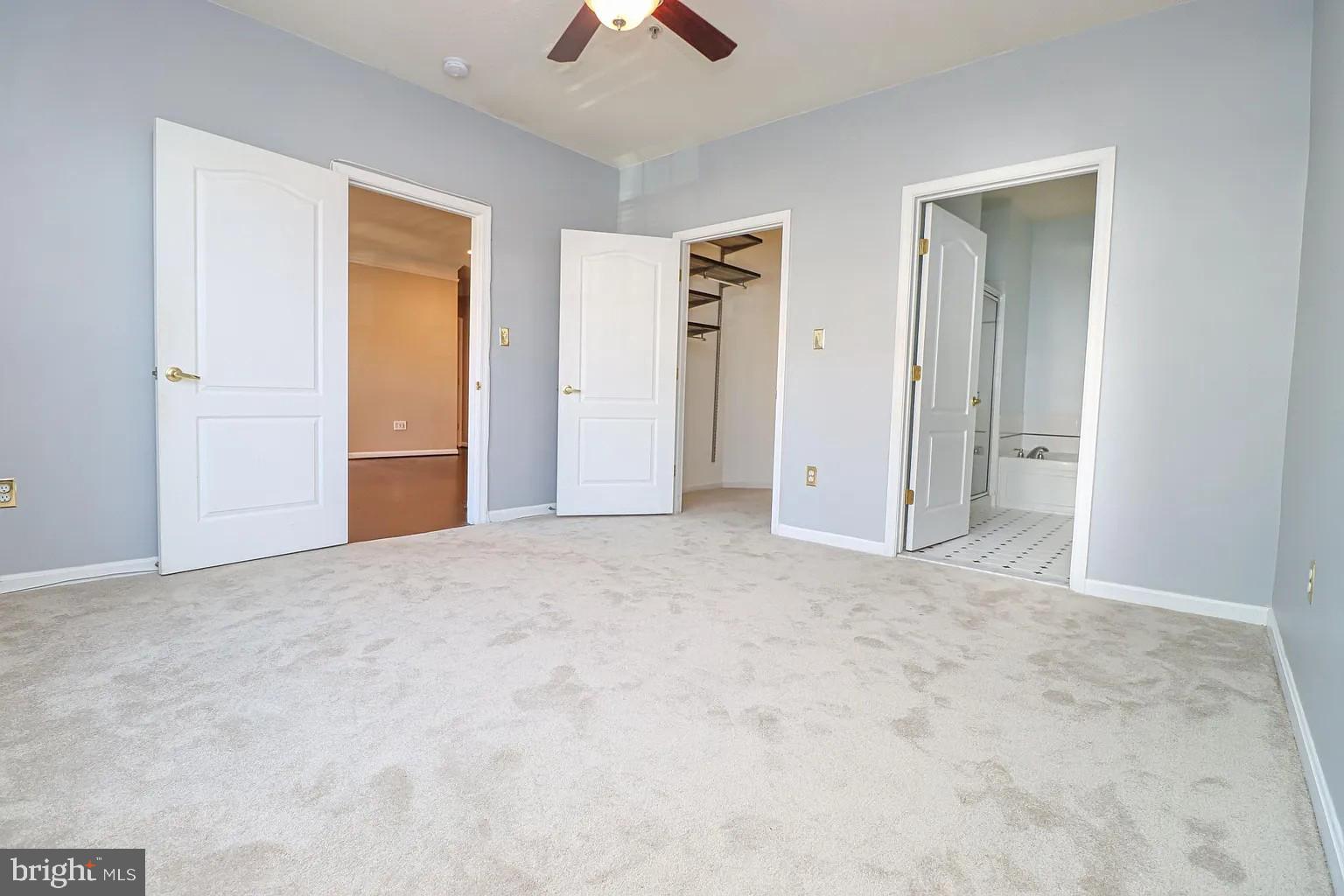 12185 Abington Hall Place, Unit 201 Reston, VA 20190 - Photo 10 of 32 an empty room with closet and a chandelier fan