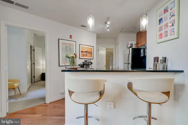 a kitchen with stainless steel appliances granite countertop a sink and a refrigerator