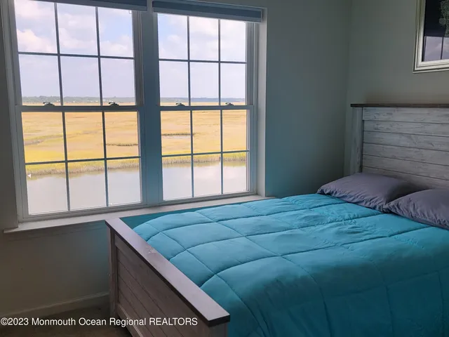 a bed sitting in a bedroom next to a window