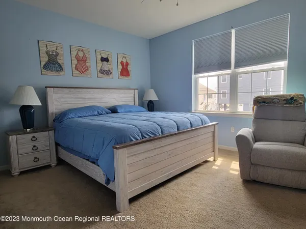 a bedroom with a bed and a couch