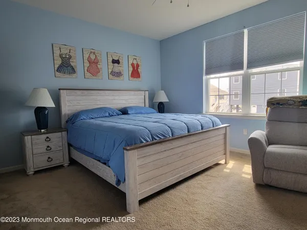 a bedroom with a bed and a couch