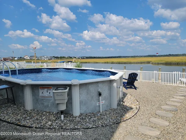 a view of a swimming pool with an outdoor seating and a yard
