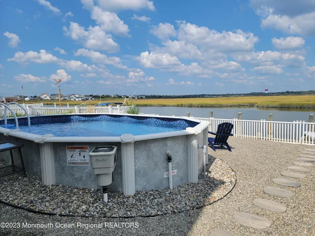 a view of a swimming pool with an outdoor seating and a yard