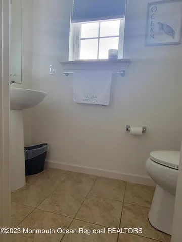 a bathroom with a toilet and a window