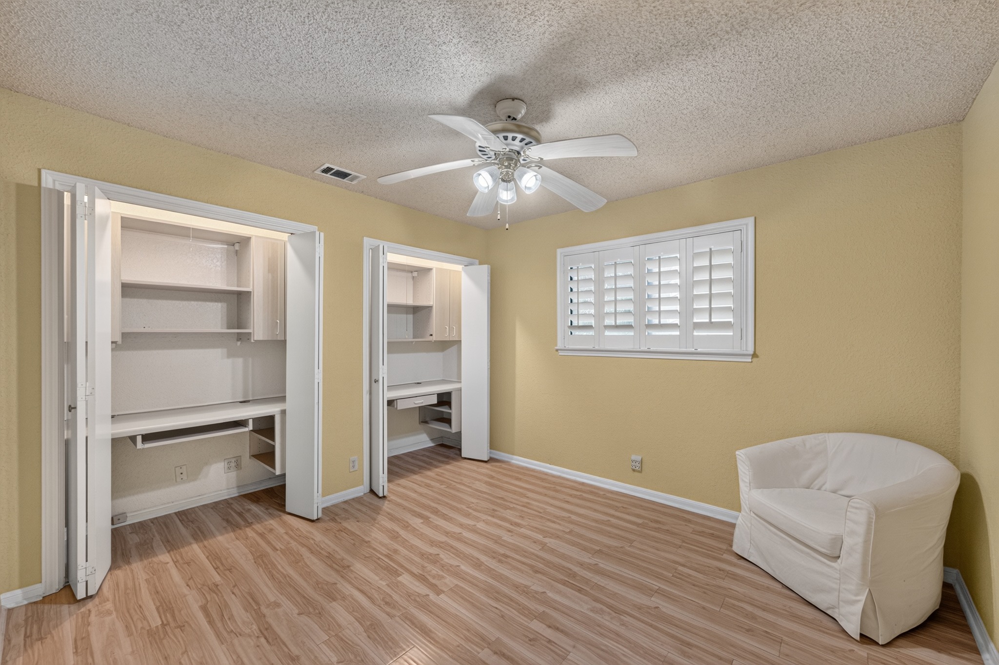 1907 Stoneridge Road Austin, TX 78746 - Photo 27 of 36 Versatile bedroom or office with two built-in workstation closets.