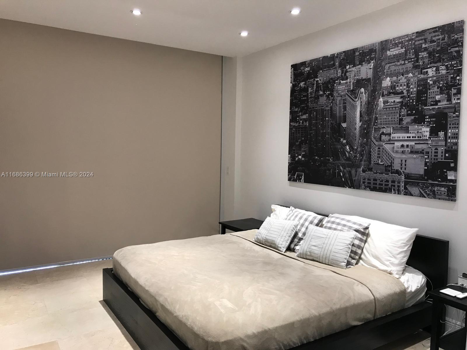 1865 Brickell Avenue, Unit APH6 Miami, FL 33129 - Photo 12 of 24 a bedroom with a bed and window
