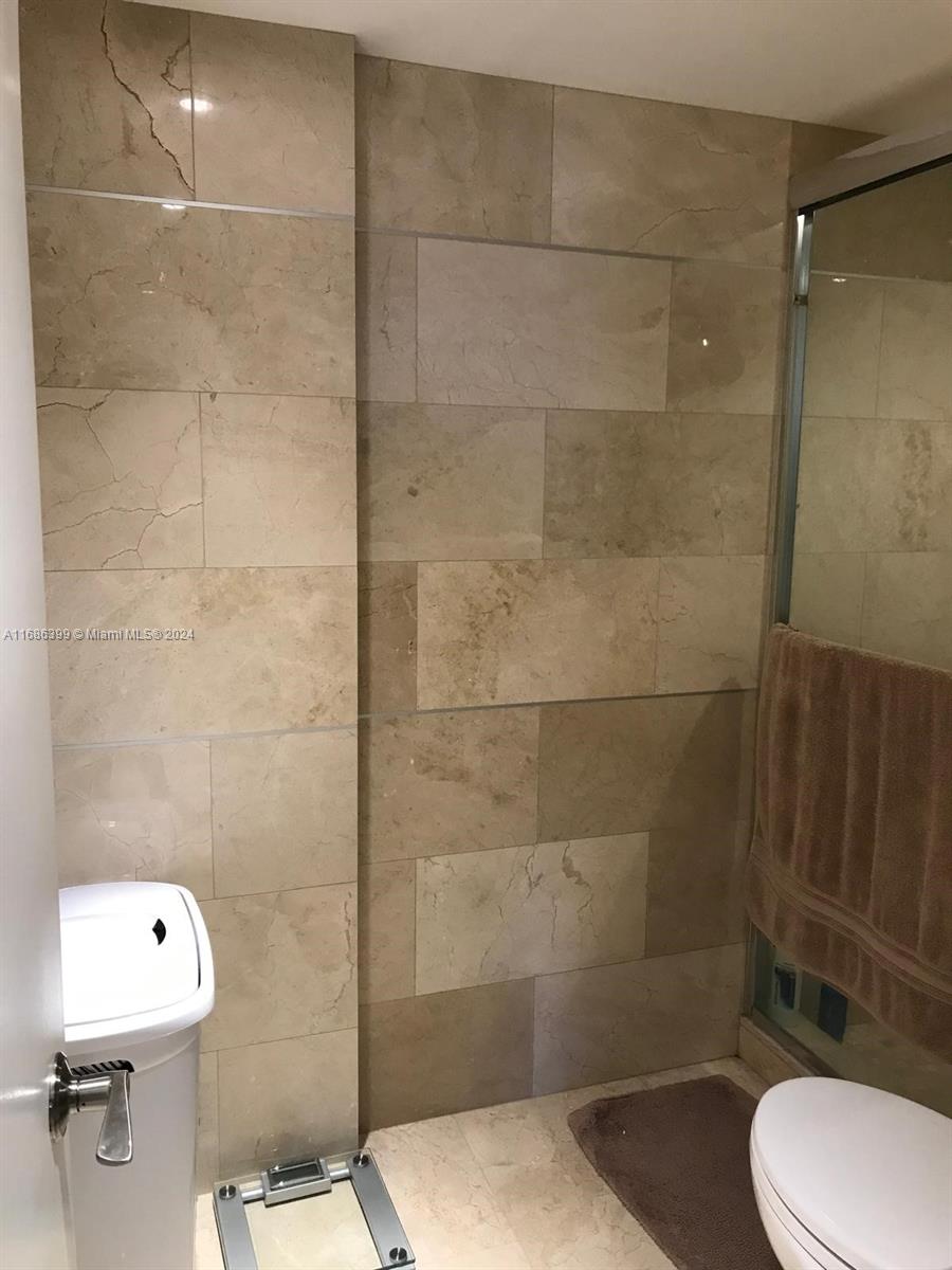 1865 Brickell Avenue, Unit APH6 Miami, FL 33129 - Photo 14 of 24 a bathroom with a toilet and a shower