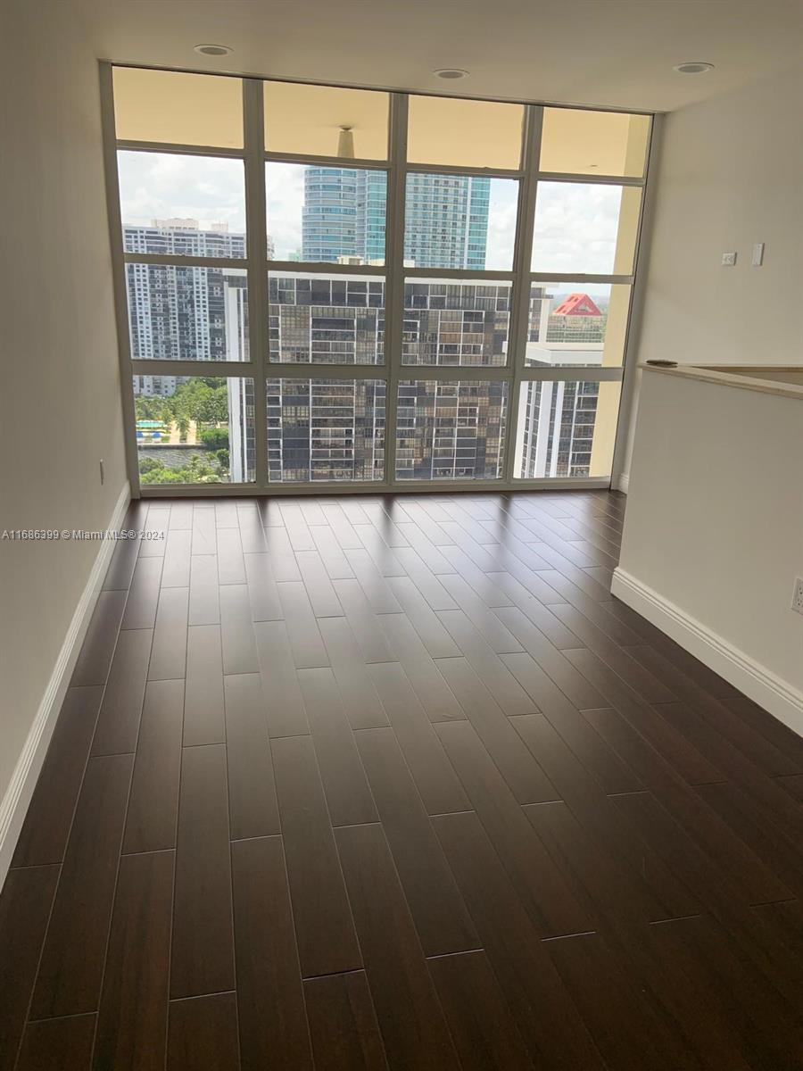 1865 Brickell Avenue, Unit APH6 Miami, FL 33129 - Photo 16 of 24 wooden floor in an empty room with a window