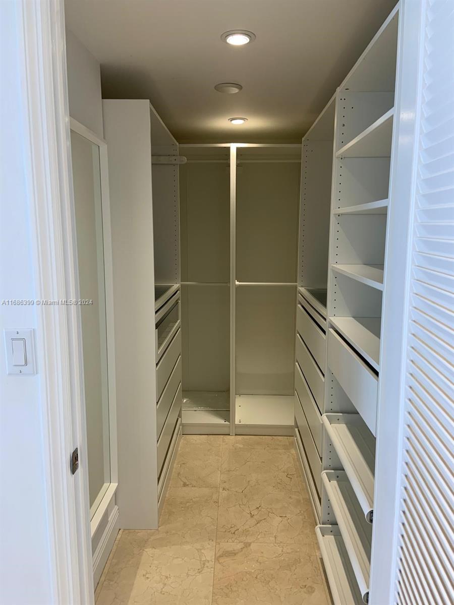 1865 Brickell Avenue, Unit APH6 Miami, FL 33129 - Photo 18 of 24 a view of an empty walk in closet