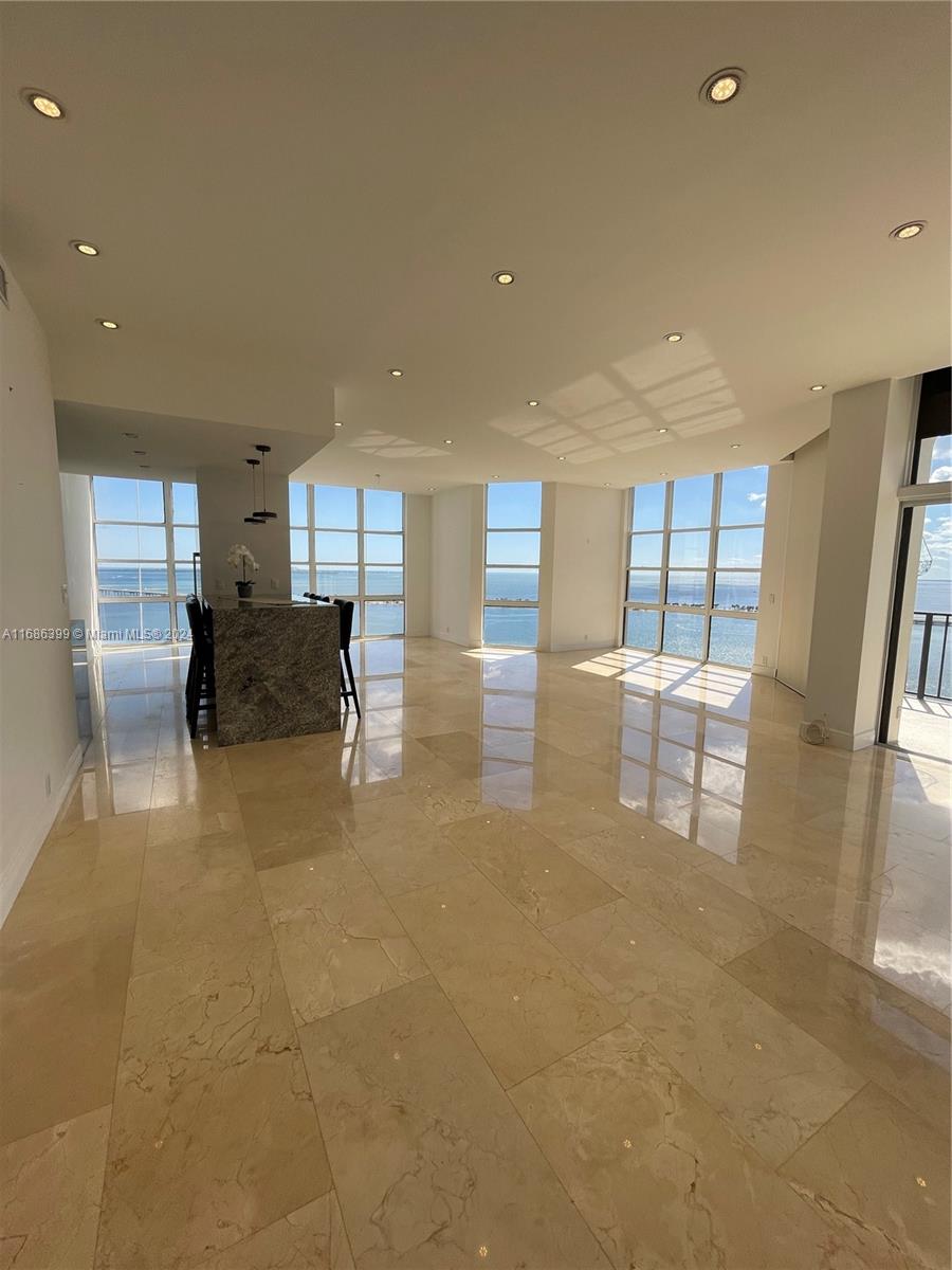 1865 Brickell Avenue, Unit APH6 Miami, FL 33129 - Photo 2 of 24 a living room with furniture and a large window