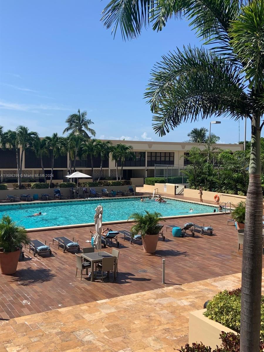 1865 Brickell Avenue, Unit APH6 Miami, FL 33129 - Photo 21 of 24 a swimming pool with outdoor seating and yard