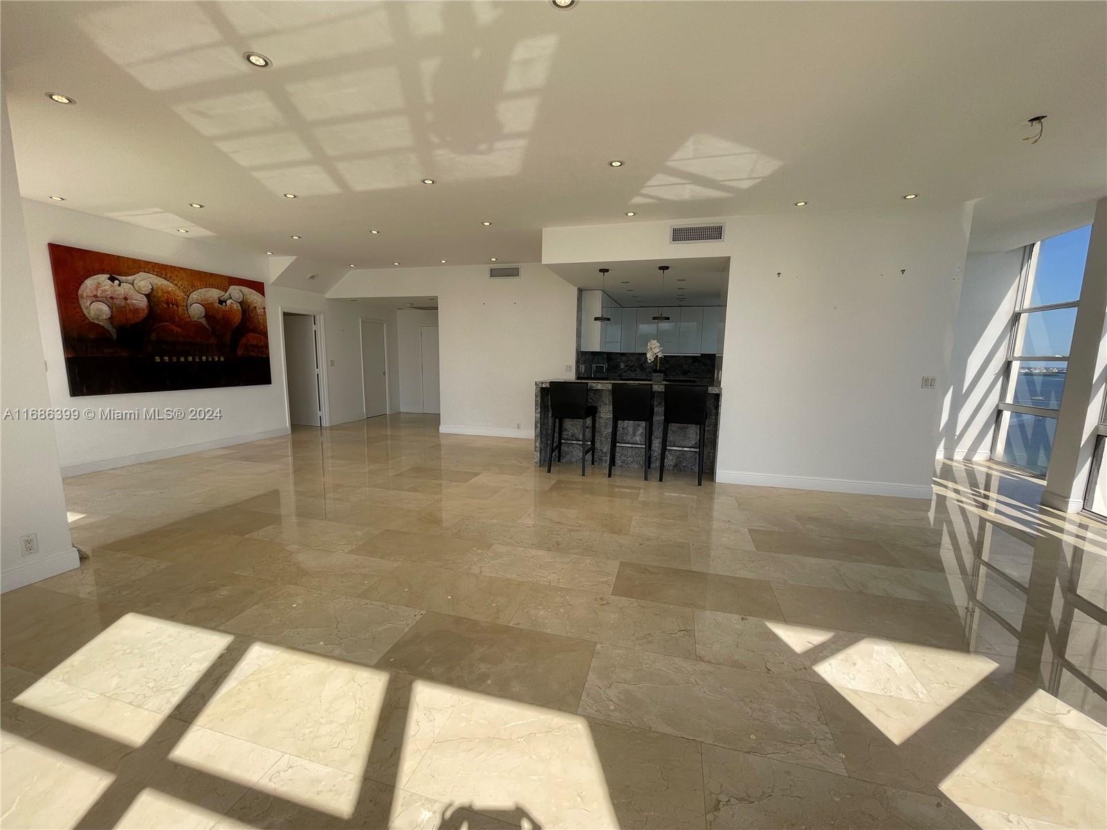 1865 Brickell Avenue, Unit APH6 Miami, FL 33129 - Photo 3 of 24 a view of livingroom with furniture and flat screen tv